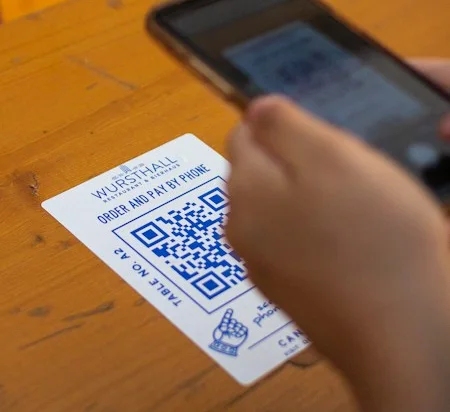 Customer scanning a table QR code menu
